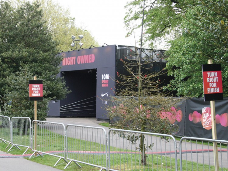 Event branding for the stage area, along with wayfinding signage and graphics wraps applied to heras fencing